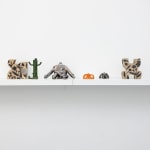 white shelf with assorted small figure statues by Jocelyn Tsaih