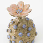 Jen Dwyer sculpture - round tan plant with blue dots all over and pink flower on top