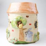 Katie Kimmel ceramic vase made to look like a house with dogs surrounding it
