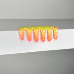 blob sculpture with green, yellow, and pink coloration