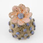Jen Dwyer sculpture - round tan plant with blue dots all over and pink flower on top