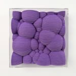 Textured purple square made from felt with a clear acrylic frame
