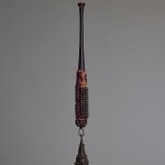 suspended mixed media bat sculpture with a bronze bell hanging at the end by Lucien Shapiro