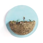 mini scene of a man killing another in a desert like landscape