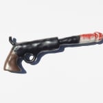 ceramic sculpture of a gun with a penis coming out of the barrel