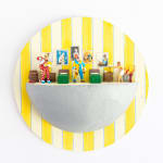 miniature diorama by Abigail Goldman of two clowns holding dismembered body parts and another victim off to the side