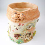 Katie Kimmel ceramic vase made to look like a house with dogs surrounding it