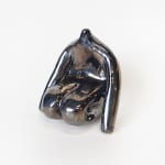 ceramic piece by Jocelyn Tsaih of a silver figure sitting