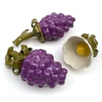 Sculptures of two purple berries and a white flower