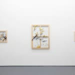 white wall with three different paintings displayed