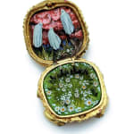 hand-cut watercolor collage in antique cosmetic compact by Shannon Taylor with three hovering ghost on red sky background and white daisies below