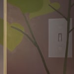 detail of a painting on a wooden room divider by artist Adrian Kay Wong depicting layered composition of an interior setting with two individuals sitting at a table, obscured by a partially opened door and door frame respectively