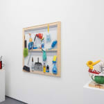 white wall with a painting in the middle and sculptures displayed on either side