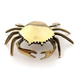 Sculpture of a brass crab with an underwater scene inside of the crab shell