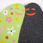 Lorien Stern's ceramic sculpture of two ghosts one black and one green with flowers