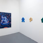 white gallery walls with a painting and colorful wooden figures by Jocelyn tsaih