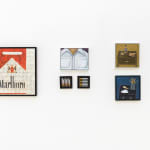 photo of a various paintings hung on a white wall