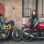 Photo of two women sitting on red and yellow motorcycles