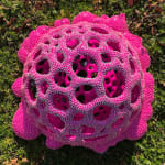 Sculpture by Dan Lam of a drippy sphere covered in tiny spikes with small holes in broken out of it