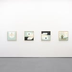white gallery wall with blue, black, and yellow toned paintings hung evenly in a line