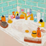 white bathroom sink countertop covered with different toiletries and blue tile behind it