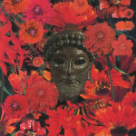brown statue head surrounded by various red flowers