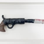 ceramic sculpture of a gun with a penis coming out of the barrel