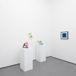 white gallery walls with small artworks and sculptures