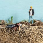 mini scene of a man killing another in a desert like landscape