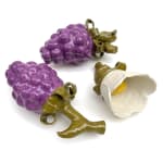 Sculptures of two purple berries and a white flower