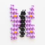 wooden sculpture of a purple by butterfly hanging on a wall by casey gray