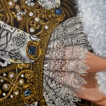 Detail photograph of the ornate fabric and lace cuff by Sabrina Bockler