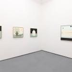 White gallery with four paintings in blue, black, and warm toned colors