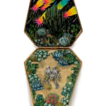 hand-cut watercolor collage in antique cosmetic compact by Shannon Taylor of two skeletons laying down on the ground with cactus surrounding them and colorful stars above them