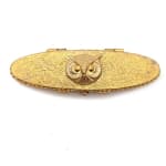 gold oval cosmetic compact with gold owl and engraving