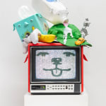 red vintage tv showing a static-y cartoon dog face with various household objects stacked on top with dog face