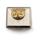square silver cosmetic case with owl gold face