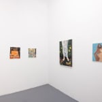 Whtie gallery walls with paintings of various sizes on the wslls