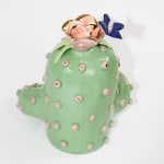 back of Jen Dwyer sculpture of green cactus with pink lips holding laptop, banana and Nutella jar
