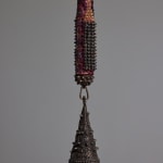 detail of the bronze bell attached to the mixed media bat sculpture by Lucien Shapiro