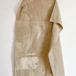 tan linen cloth embroidered with leaves and abstract shapes