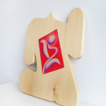 side view wooden sculpture with small inlaid red canvas by Jocelyn Tsaih