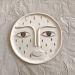 the moon with a face and a droplet pattern made from ceramic clay
