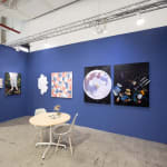 installation view of Hashimoto Contemporary booth at future fair featuring paintings on dark blue walls