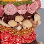Detail of Lindsey Lou Howard sculpture of giant burger with onions, tomatoes, mushrooms, all in excessive amounts