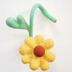 yellow flower sculpture supported by green stems