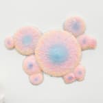 Sculpture with multiple circular objects with a pink to purple gradient by Dan Lam.