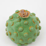 Jen Dwyer sculpture - round green plant with pink flower on top