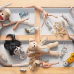 painting of broken dolls and stuffed animals suspended in the air