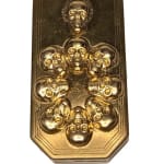 gold rectangular compact with several gold skulls
